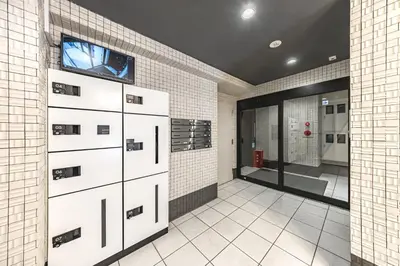 a bathroom with white cabinets and a tv on the wall at R STAY Oshiage 201 in Tokyo