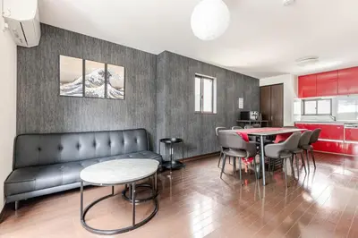 a living room with a couch and a table and chairs at jtr\u6771\u5927\u4e952\u4e01\u76ee in Tokyo
