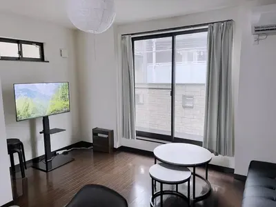 a living room with a table and a large window at jtr\u6771\u5927\u4e952\u4e01\u76ee in Tokyo