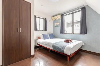 a bedroom with a bed and a large window at jtr\u6771\u5927\u4e952\u4e01\u76ee in Tokyo