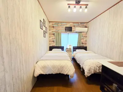 two beds in a room with a room with two at 202 Koiwa st private Room in Tokyo
