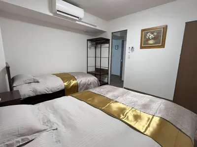 a room with three beds with white and gold sheets at \u6771\u4eac\u6d45\u8349\u30a4\u30f3301 in Tokyo