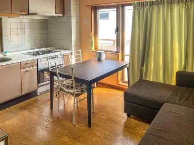 a small kitchen with a table and a couch at \u6e21\u8fb9\u30d3\u30eb103 in Tokyo