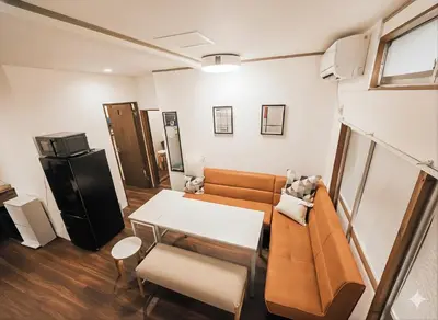 a living room with a couch and a table at KASHIMA -JR Otsuka Station- in Tokyo