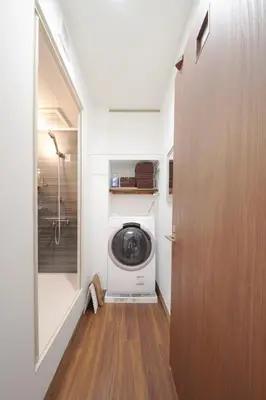 a laundry room with a washer and dryer in it at KASHIMA -JR Otsuka Station- in Tokyo