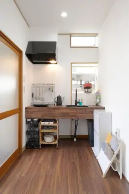 a kitchen with a wooden counter top in a room at KASHIMA -JR Otsuka Station- in Tokyo