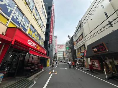 an empty street in a city with buildings at Ficus Tokyo in Tokyo