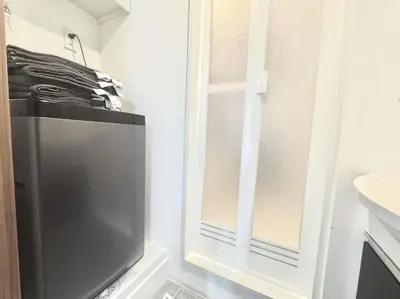 a television in a bathroom next to a sink at ToyoHomes\u897f\u65b0\u5bbf in Tokyo