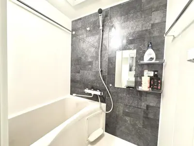 a bathroom with a white tub and a shower at ToyoHomes\u897f\u65b0\u5bbf in Tokyo