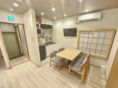 a kitchen and dining room with a table and chairs at Nanayado Asakusa Okachimachi in Tokyo