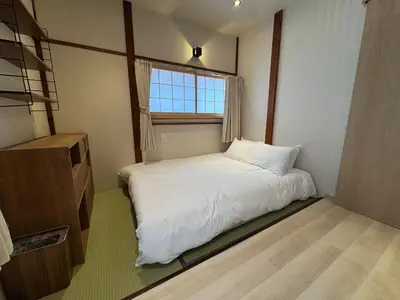 a small bedroom with a white bed and a window at Nanayado Asakusa Okachimachi in Tokyo