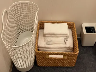 a basket filled with towels in a bathroom at Nanayado Asakusa Okachimachi in Tokyo