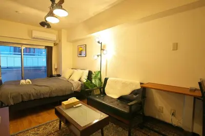 a bedroom with a bed and a chair and a table at Zen Abode \u82b3 4 minutes walk from station cafe-like in Tokyo