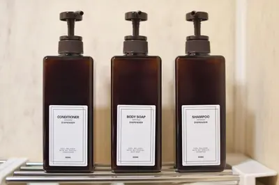 a group of four bottles sitting on a shelf at Zen Abode \u82b3 4 minutes walk from station cafe-like in Tokyo