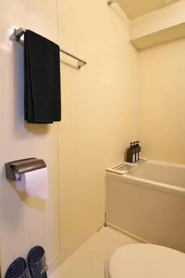 a bathroom with a toilet and a black towel at Zen Abode \u82b3 4 minutes walk from station cafe-like in Tokyo
