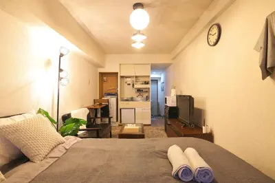 a bedroom with a bed with two towels on it at Zen Abode \u82b3 4 minutes walk from station cafe-like in Tokyo