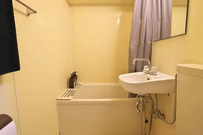 a small bathroom with a sink and a bath tub at Zen Abode \u82b3 4 minutes walk from station cafe-like in Tokyo