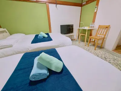 a hotel room with two beds and a tv at \u6c60\u888b1F 2bedrooms Suite Cozy for 1-4 guests in Tokyo