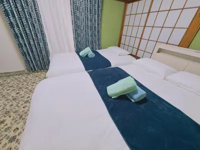 two beds in a hotel room with white sheets at \u6c60\u888b1F 2bedrooms Suite Cozy for 1-4 guests in Tokyo