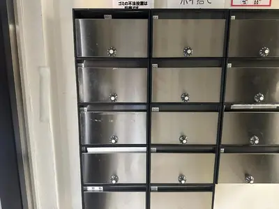 a black shelving unit with silver knobs on it at West Shinjuku Nakano Family Inn in Tokyo