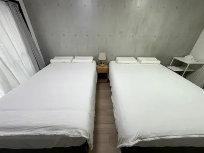 two beds sitting next to each other in a room at West Shinjuku Nakano Family Inn in Tokyo