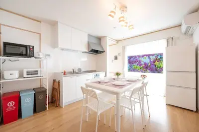 a kitchen with a white table and chairs in a room at bai\u56db\u3064\u67282\u4e01\u76ee101 in Tokyo