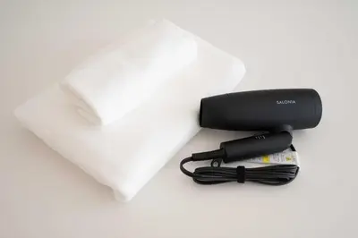 a hair dryer with a cord next to a towel at bai\u56db\u3064\u67282\u4e01\u76ee101 in Tokyo