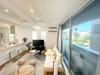 a living room with a large window and a pool at Y-city house in Tokyo
