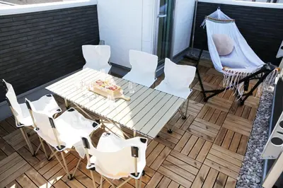 a table and chairs on a balcony with a cake at Y-city house in Tokyo
