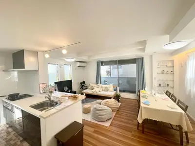 a kitchen and living room with a table and a couch at Y-city house in Tokyo