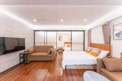 a hotel room with a bed and a couch at Tabist HOTEL UENO 39 in Tokyo