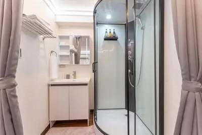 a bathroom with a shower and a sink at Tabist HOTEL UENO 39 in Tokyo