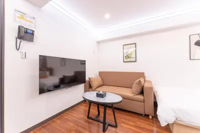 a living room with a couch and a table at Tabist HOTEL UENO 39 in Tokyo