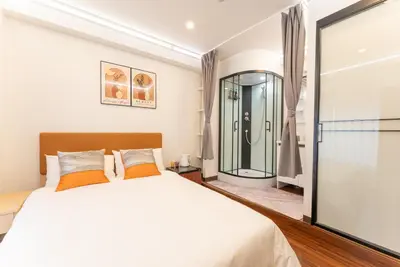 a bedroom with a large bed and a glass shower at Tabist HOTEL UENO 39 in Tokyo