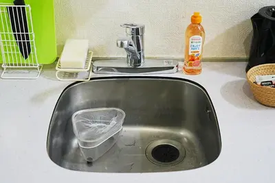 a kitchen sink with a dish strainer in it at SC 105 Cozy Private Stay with Loft Near Station Free WiFi in Tokyo