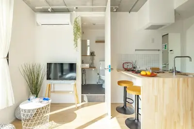 a kitchen with a counter and stools in a room at NewOpen,\u65b0\u5bbf,\u4e2d\u91ce,SHINJUKU,NAKANO,Parkview,Art,trias234 vacation stay in Tokyo