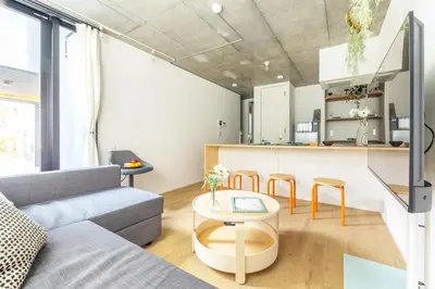 a living room with a couch and a table at NewOpen,\u65b0\u5bbf,\u4e2d\u91ce,SHINJUKU,NAKANO,Parkview,Art,trias234 vacation stay in Tokyo