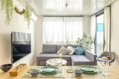 a living room with a couch and a table at NewOpen,\u65b0\u5bbf,\u4e2d\u91ce,SHINJUKU,NAKANO,Parkview,Art,trias234 vacation stay in Tokyo