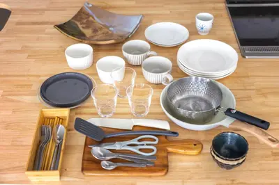 a table with plates and utensils and a laptop at NewOpen,\u65b0\u5bbf,\u4e2d\u91ce,SHINJUKU,NAKANO,Parkview,Art,trias234 vacation stay in Tokyo