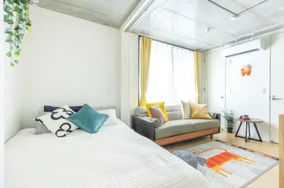 a bedroom with a bed and a couch at NewOpen,\u65b0\u5bbf,\u4e2d\u91ce,SHINJUKU,NAKANO,Parkview,Art,trias234 vacation stay in Tokyo