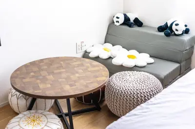 a room with a table and a couch with stuffed pandas on the couch at NewOpen,\u65b0\u5bbf,\u4e2d\u91ce,SHINJUKU,NAKANO,Parkview,Art,trias234 vacation stay in Tokyo