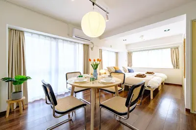 a dining room and living room with a table and chairs at Palaisgrace Shibuya - Live Like a Trendy Local in Sangenjaya \u4e09\u8ed2\u8336\u5c4b - Direct Shibuya Access in Tokyo