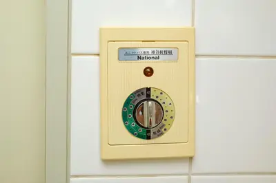 a light switch on a tiled wall at Palaisgrace Shibuya - Live Like a Trendy Local in Sangenjaya \u4e09\u8ed2\u8336\u5c4b - Direct Shibuya Access in Tokyo