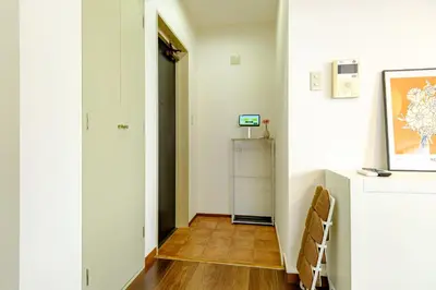 a hallway with white walls and a wooden floor at Palaisgrace Shibuya - Live Like a Trendy Local in Sangenjaya \u4e09\u8ed2\u8336\u5c4b - Direct Shibuya Access in Tokyo
