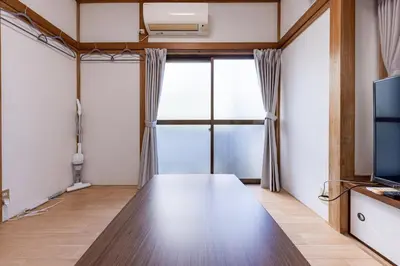 a living room with a table and a tv at tokyo \u738b\u5b50 hotel in Tokyo
