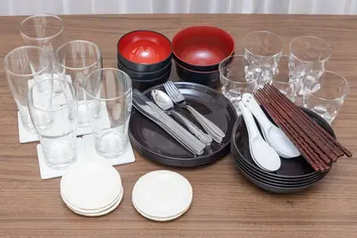 a table topped with black plates and wine glasses at tokyo \u738b\u5b50 hotel in Tokyo
