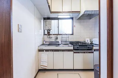 a small kitchen with a sink and a stove at tokyo \u738b\u5b50 hotel in Tokyo