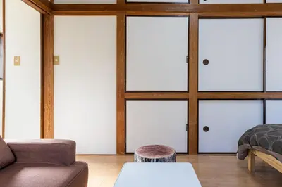 a living room with four sliding glass doors at tokyo \u738b\u5b50 hotel in Tokyo