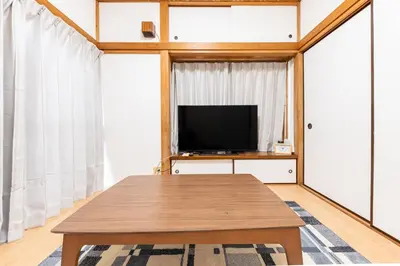a living room with a table and a television at tokyo \u738b\u5b50 hotel in Tokyo