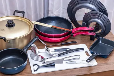 a table with cooking utensils and a pot and pans at tokyo \u738b\u5b50 hotel in Tokyo
